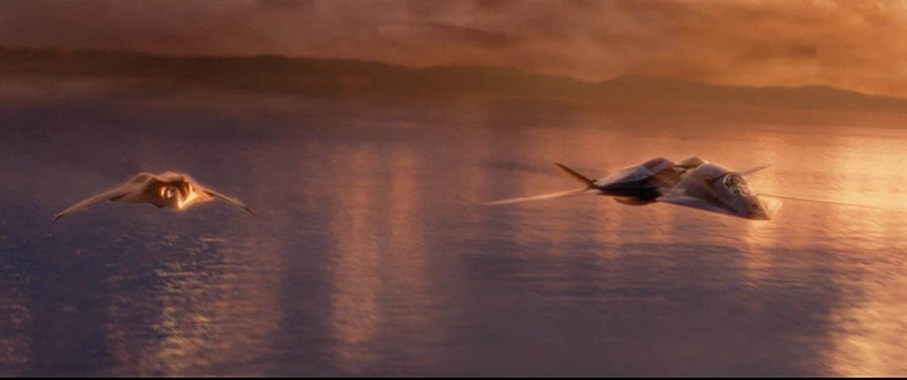 2 fighter planes in low clouds over Lake Baikal at sunset.